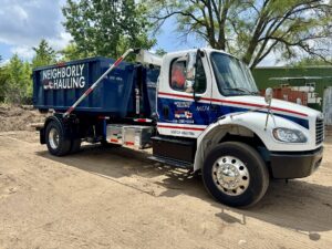 Neighborly Hauling dumpster truck parked with loaded 11 yard container
