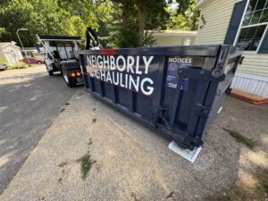 12 yard dumpster in small Grand Rapids driveway with tight space access