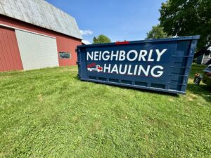 25 yard dumpster rental placed on grass at a Kent County barn cleanup